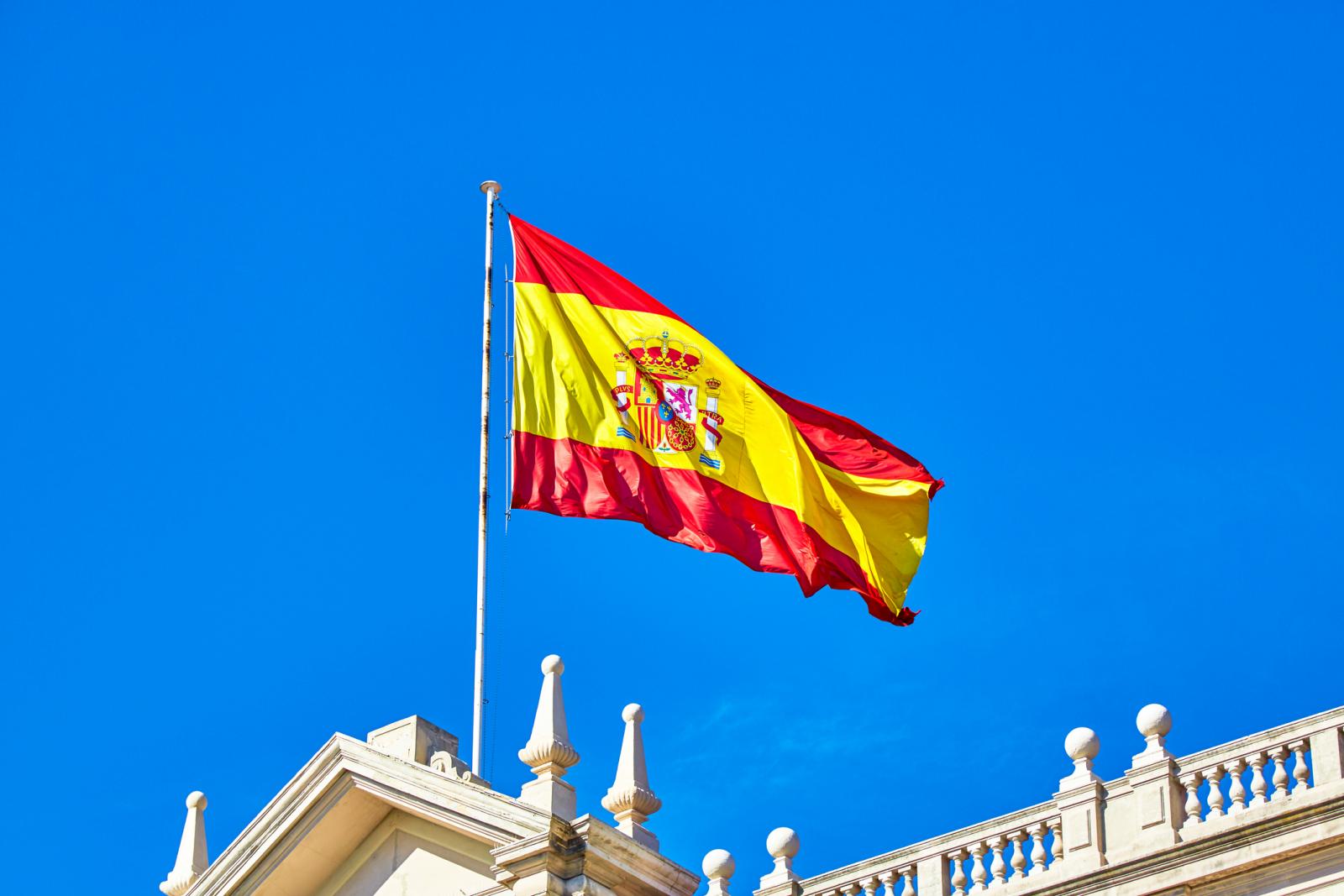 drapeau espagnol bandes rouges et jaunes flottant dans le vent et le ciel bleu
